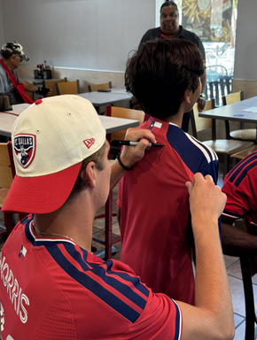Nolan Norris of FC Dallas Signs a Fans Shirt.jpg